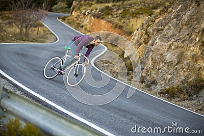 Cyclist man riding fixed gear sport bike in sunny day