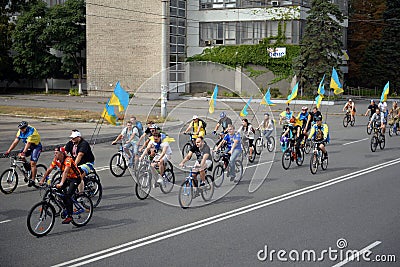 Cyclists with flags of Ukraine take the road