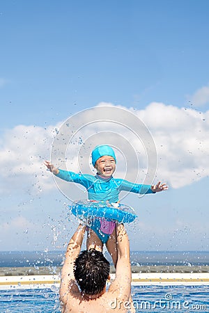 Dad and Daughter playing in swimming Pool