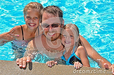 Dad with daughters in pool