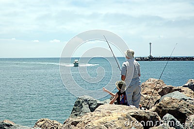 Dad and son 1 fishing at beach