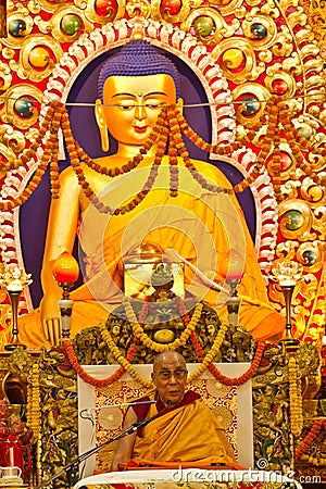 The Dalai Lama teaches beneath an ornate Buddha in Dharamsala, India, September 2014 Julian_Bound