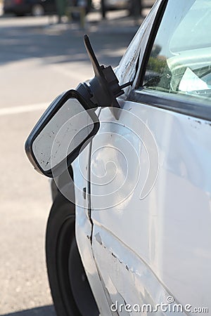 Damaged car and broken side rear view mirror.