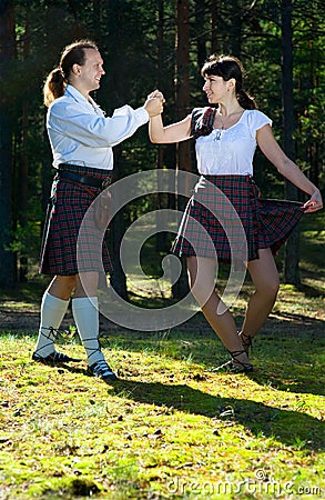 Dancing man and woman in scottish costume