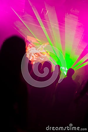 Dancing people in laser lights