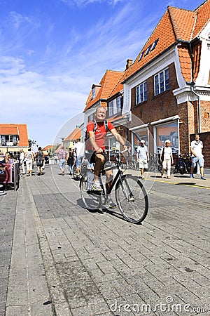 Danish man bicycling on street in Denmark