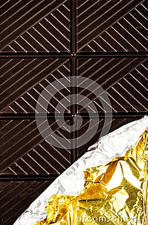 Dark Chocolate Bar in opened silver foil wrapping closeup. Choco