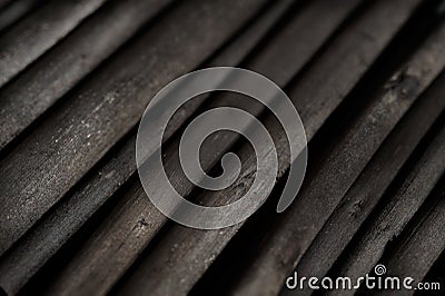 Dark gray wooden charcoal texture, close up.