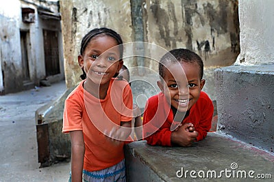 Dark skinned children, playing outdoors.