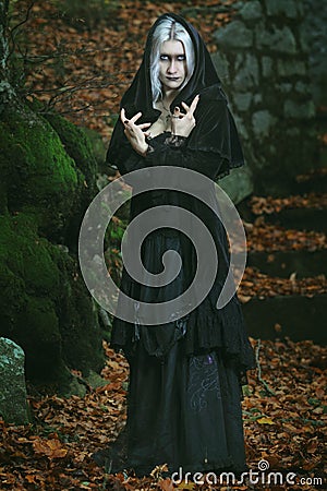 Dark witch posing in the woods