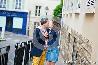 Dating couple kissing on a street of Paris