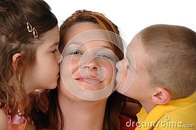 Daughter and son kissing mom