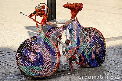 Decorative bicycle resting on a sidewalk