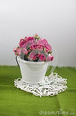 Decorative bouquet of roses in a small bucket