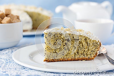 Delicious poppy seed cake with cup of tea on table