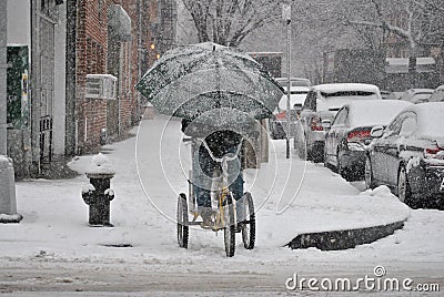 Delivery man, on bicycle in snow storm