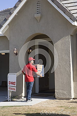 Delivery man holding Cardboard box