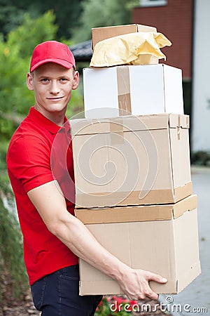 Delivery man holding cardboard boxes