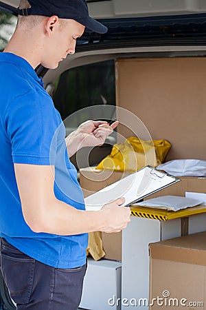 Delivery man looking at clipboard