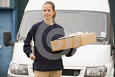 Deliveryperson standing with van with box