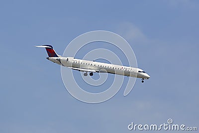 Delta Connection Bombardier CRJ-900 in New York sky before landing at JFK Airport