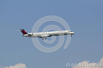 Delta Connection Bombardier CRJ-900 in New York sky before landing at JFK Airport