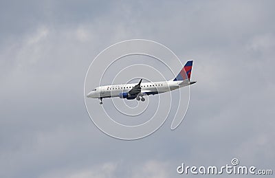 Delta Connection Embraer 175 in New York sky before landing in La Guardia Airport