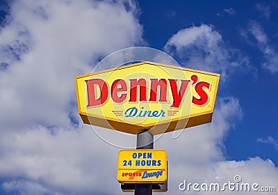 Dennys Diner sign under clouds and blue sky