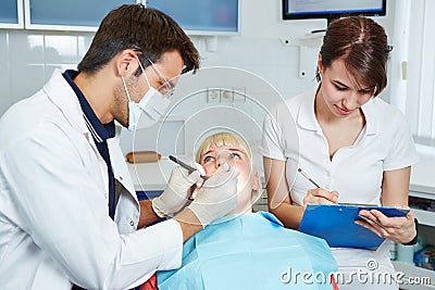 Dental assistant during apprenticeship taking notes