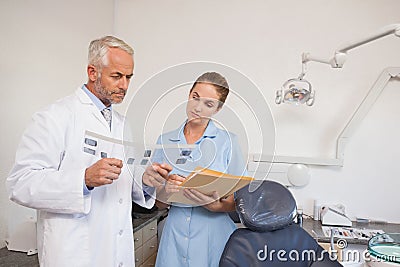 Dentist and assistant studying x-rays
