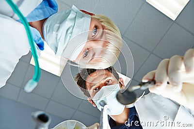 Dentist and dental assistant from patient POV