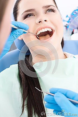 Dentist examines the oral cavity of a patient