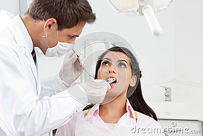 Dentist Examining Patient s Mouth