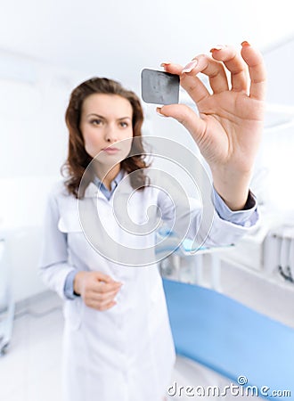 Dentist s assistant examines the x ray image