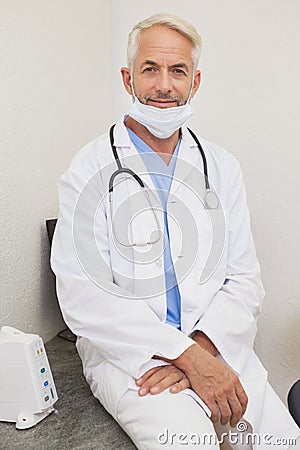 Dentist smiling at camera in lab coat