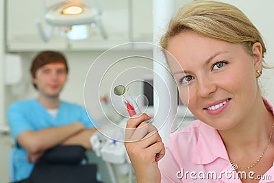 Dentist with tools in cabinet of dental clinic
