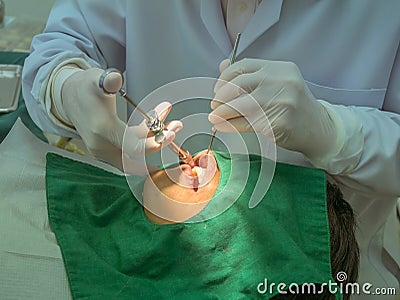 Dentist was injecting the patient s gums.