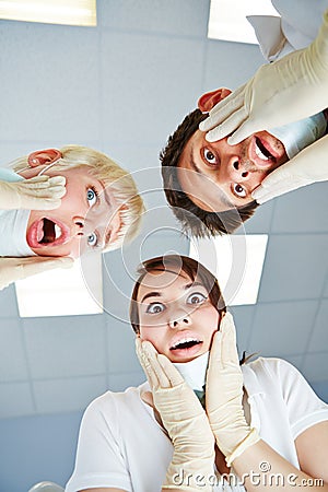 Dentists looking shocked at patient