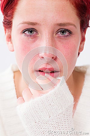 Depressed crying young redhead woman