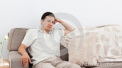 Depressed man thinking on the sofa