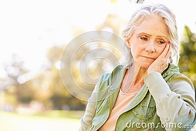 Depressed Senior Woman Sitting Outside