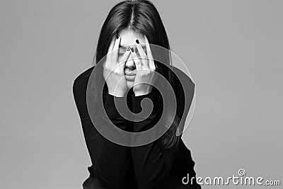 Depressed young woman with hands over her head
