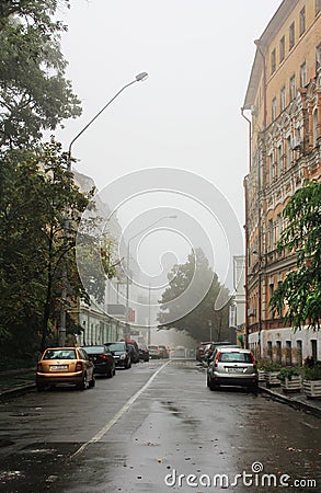 A deserted city street in foggy weather