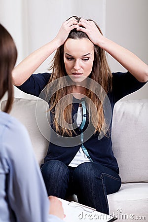 Desperate young woman on psychotherapy session