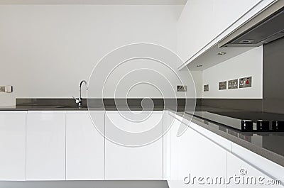 Detail of contemporary fully fitted kitchen in white