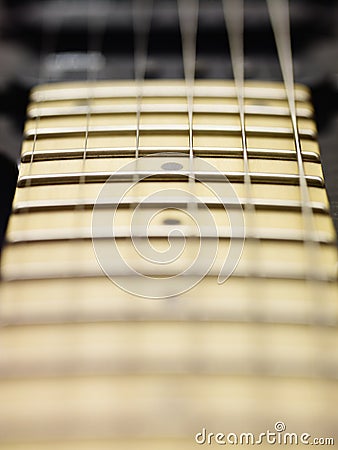 Detail of electric guitar cords and frets