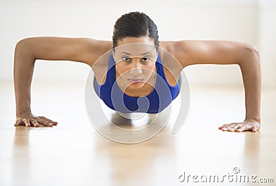 Determined Woman Doing Push Ups In Gym