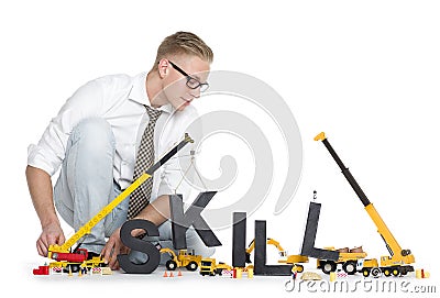 Developing skills: Businessman building skill-word