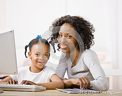 Devoted mother helping daughter do homework