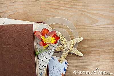Diary, old letters and red freesia flower
